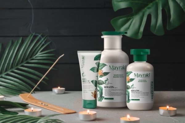..Wrap-Up Set of Mayraki hair care products displayed with candles and tropical leaves, representing a restorative routine designed to repair heat-damaged hair using nourishing, keratin-infused formulas.
