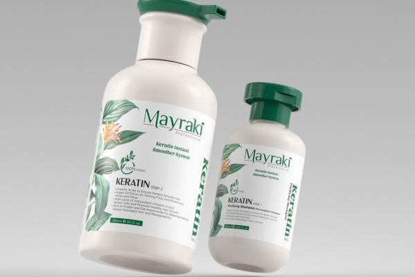 Two white bottles of Mayraki Professional Keratin Treatment with green pumps, featuring botanical artwork and text labels, displayed against a plain light gray background.